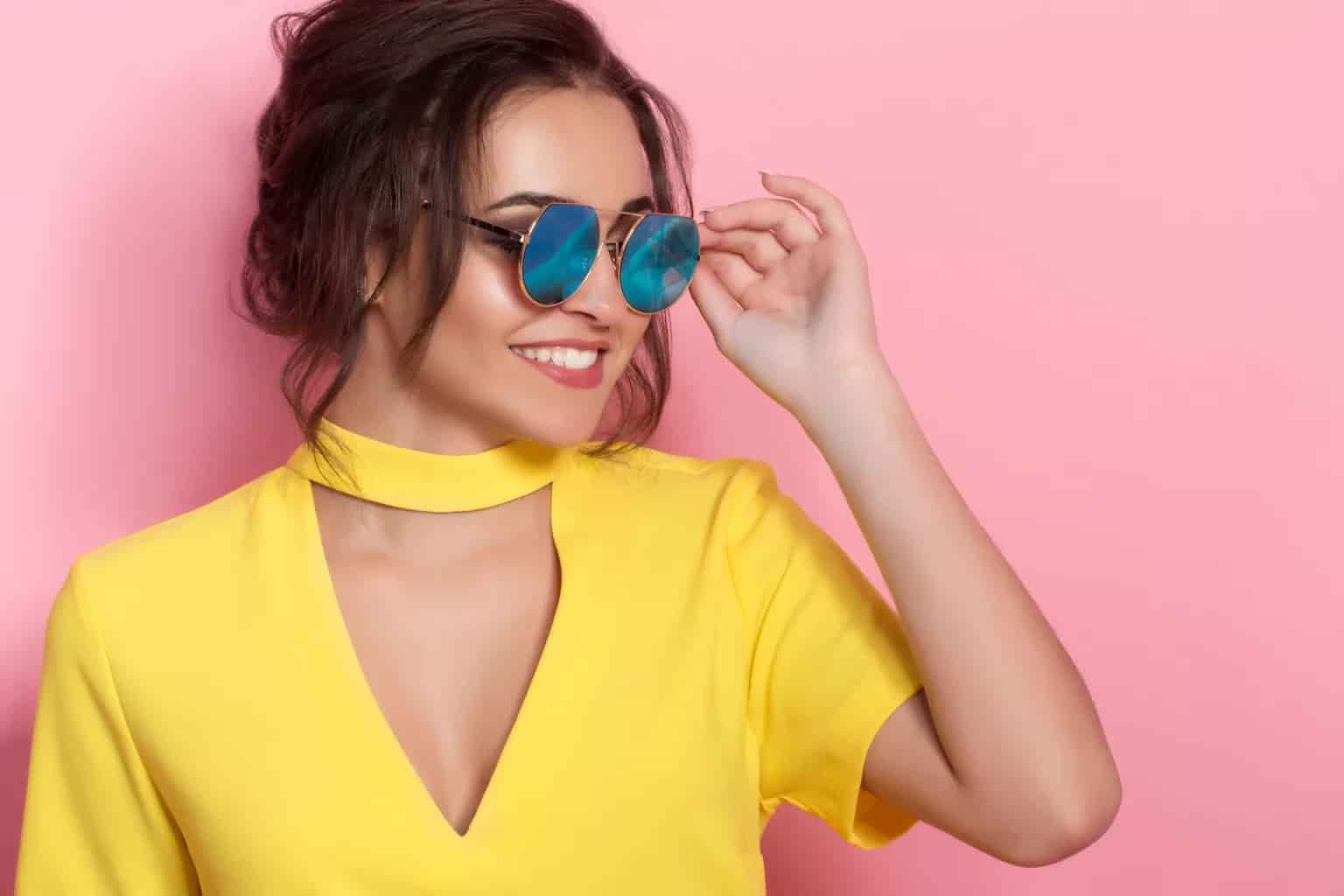 Beautiful girl in colorful clothes wearing sunglasses