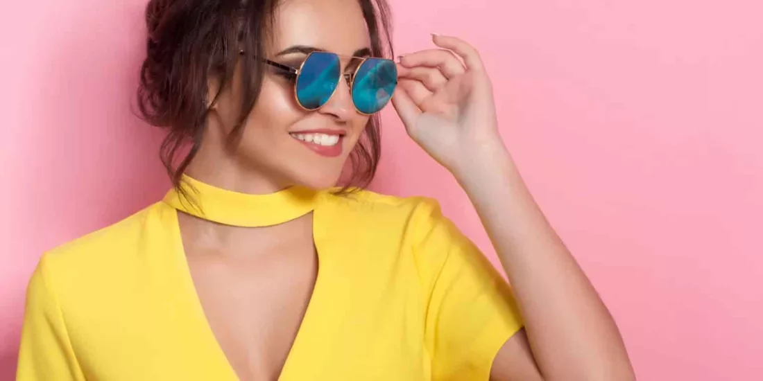 Beautiful girl in colorful clothes wearing sunglasses