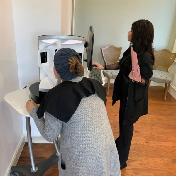 Patient is undergoing a skin assessment with VISIA Skin Analysis Device.
